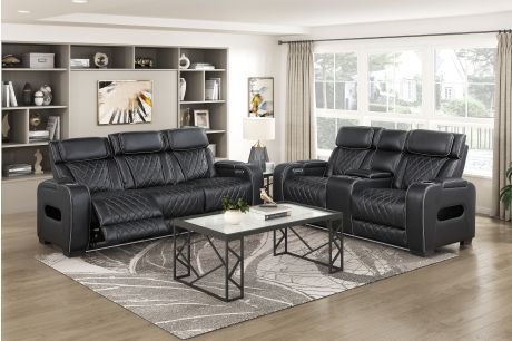 Black leather reclining sofa and loveseat set in a living room with a marble-top coffee table.