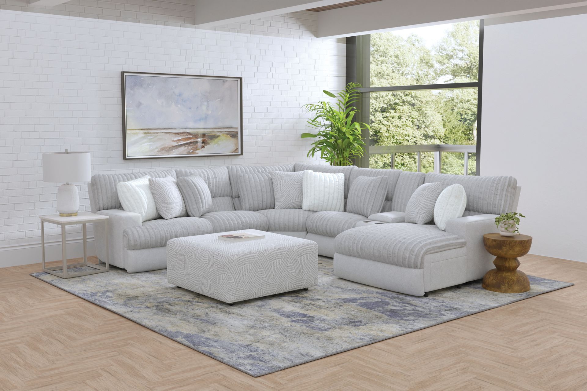 Light gray sectional sofa with ottoman in a modern living room setting.