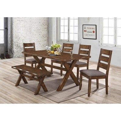 Dining set in a well-lit room: wooden table with bench and chairs, food on table.