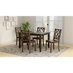 Dining room set with a brown table, four chairs, and a patterned rug.