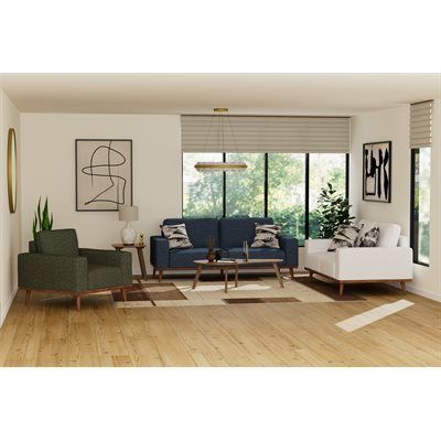 Living room with blue sofa, white loveseat, green armchair, and wooden furniture.