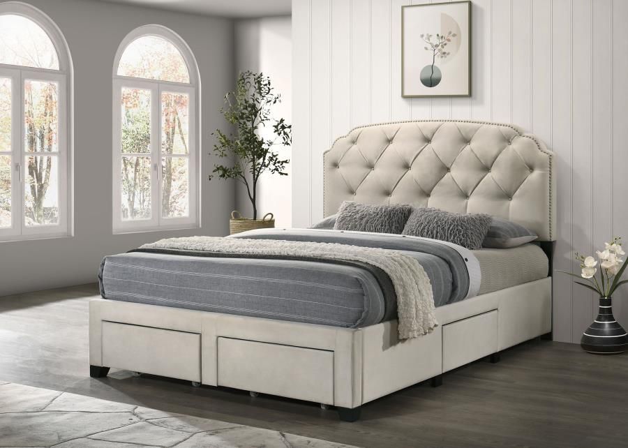 Beige upholstered bed with tufted headboard, storage drawers, and decorative pillows.