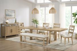 Dining room with light wood table, chairs, bench, and buffet. Neutral tones, windows, and woven pendant lights.