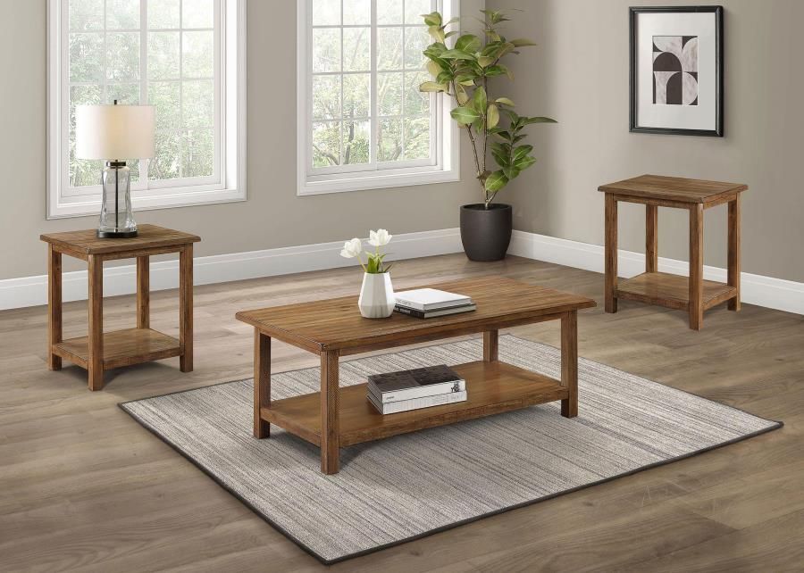 Living room furniture set: coffee table, two side tables, lamp, plant, rug. Brown wood, neutral walls.