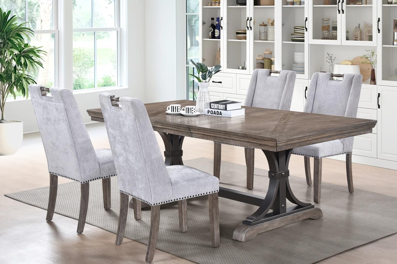 Dining table with four upholstered chairs in a bright room with a white cabinet and large window.