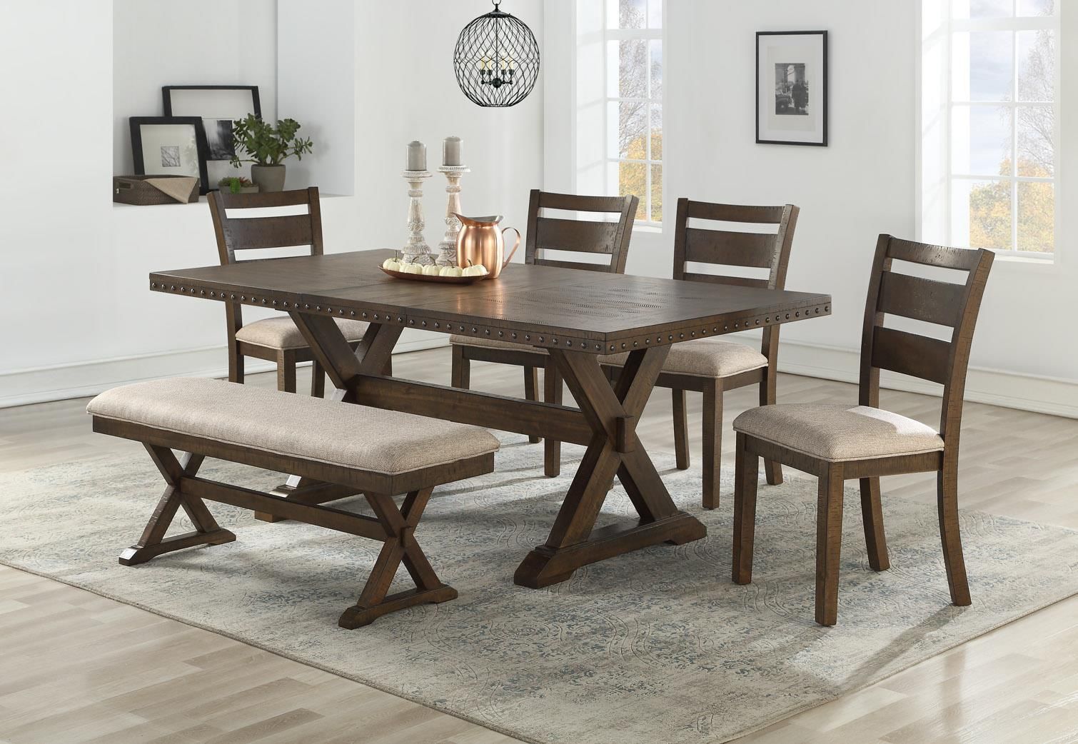 Dining room set: wooden table, bench, and chairs on a rug.