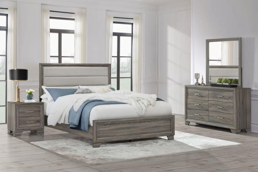 Bedroom set with a bed, dresser with a mirror, and nightstand in a well-lit room.
