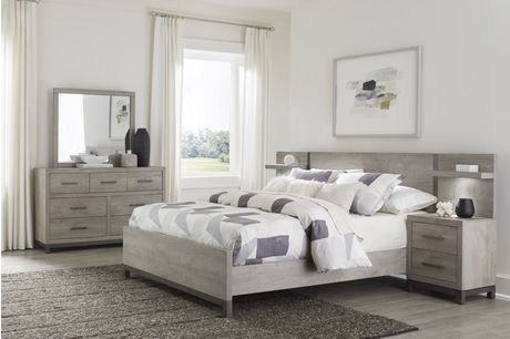 Bedroom set with a bed, nightstand, dresser, and artwork; all gray.