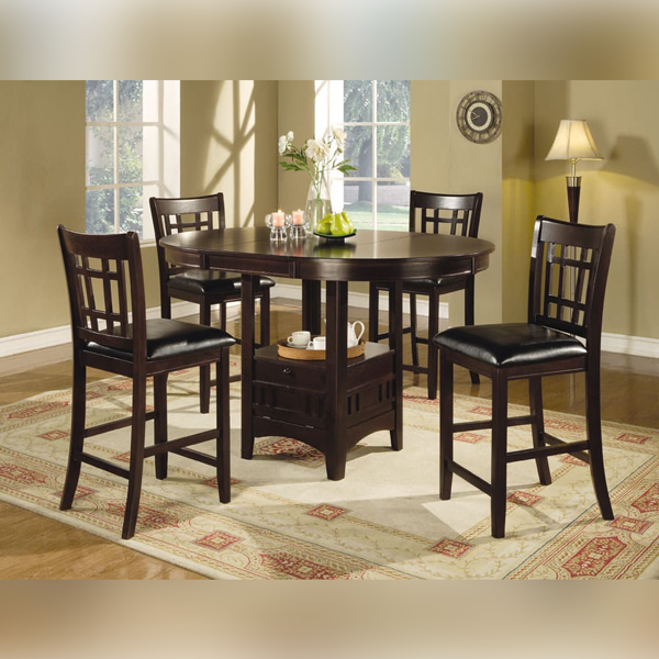 Dark wood bar table and chairs on patterned rug, set in a room with a window and lamp.