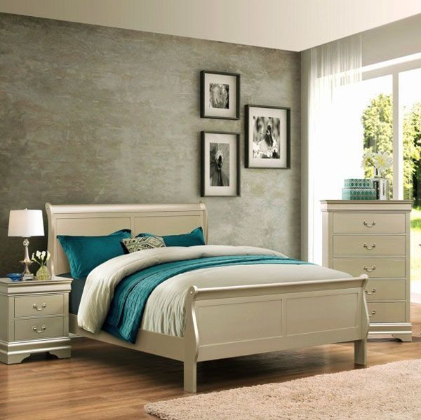 Bedroom with beige sleigh bed, nightstand, and dresser. Teal and white bedding. Three framed photos on wall.