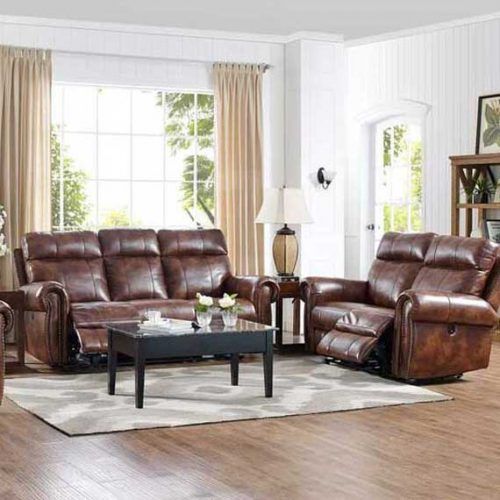 Leather reclining sofa and armchair in a living room, with a rug and curtains.