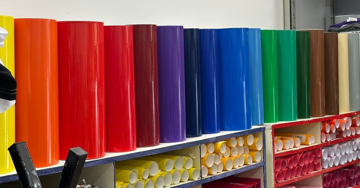 Rows of Colored Vinyl Rolls Displayed on Shelves — That Printed Vinyl Place in Heatley, QLD