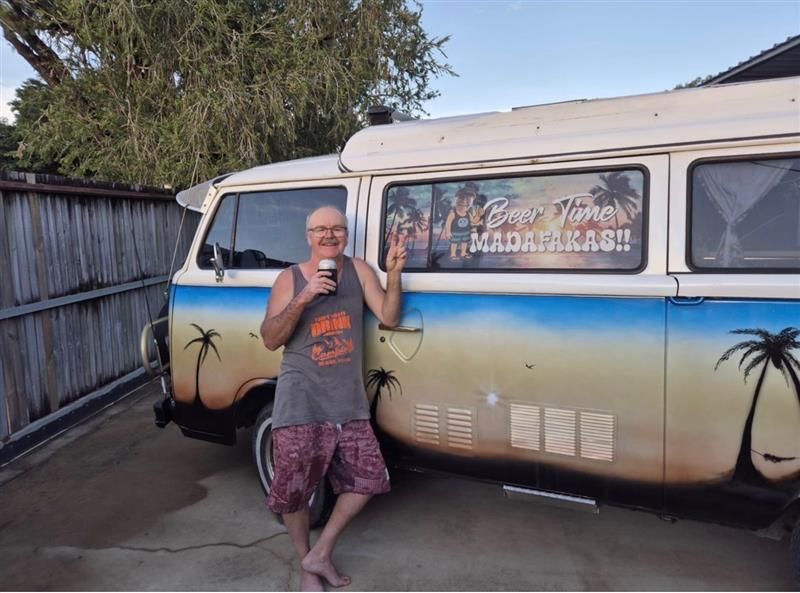 Person Standing Beside a Painted Van in a Driveway — That Printed Vinyl Place in Heatley, QLD
