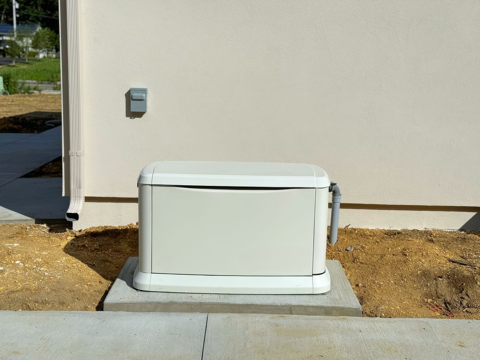 A home standby generator installed in the backyard of a house.