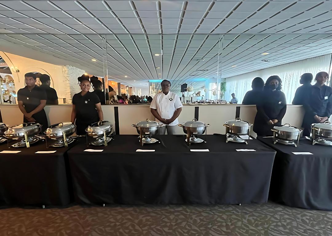 A group of people standing in front of a buffet table