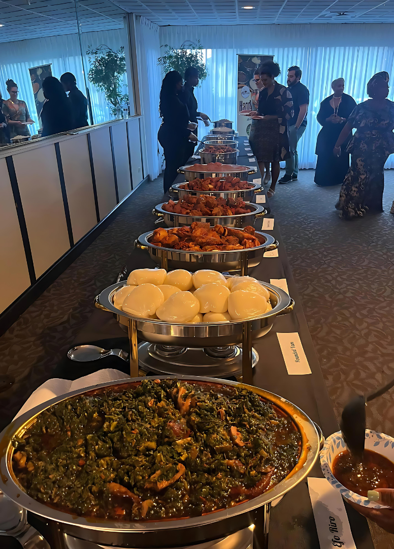 A long table with a variety of food on it.
