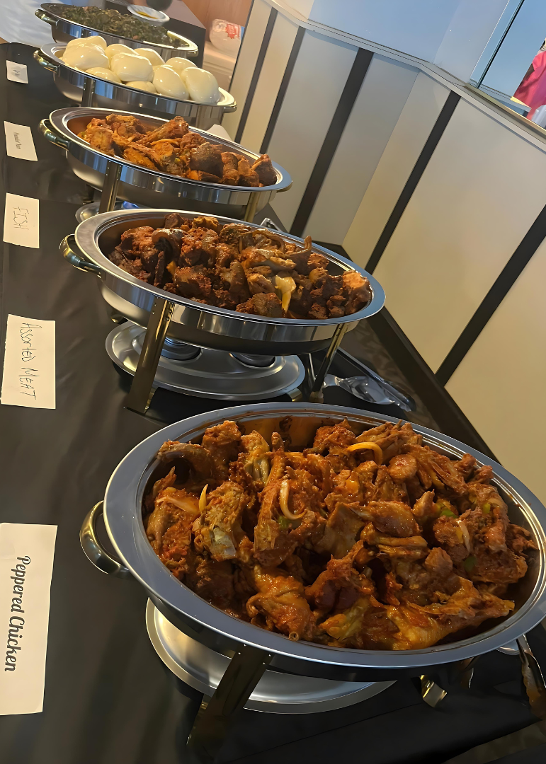 A buffet line with bowls of food on a table.