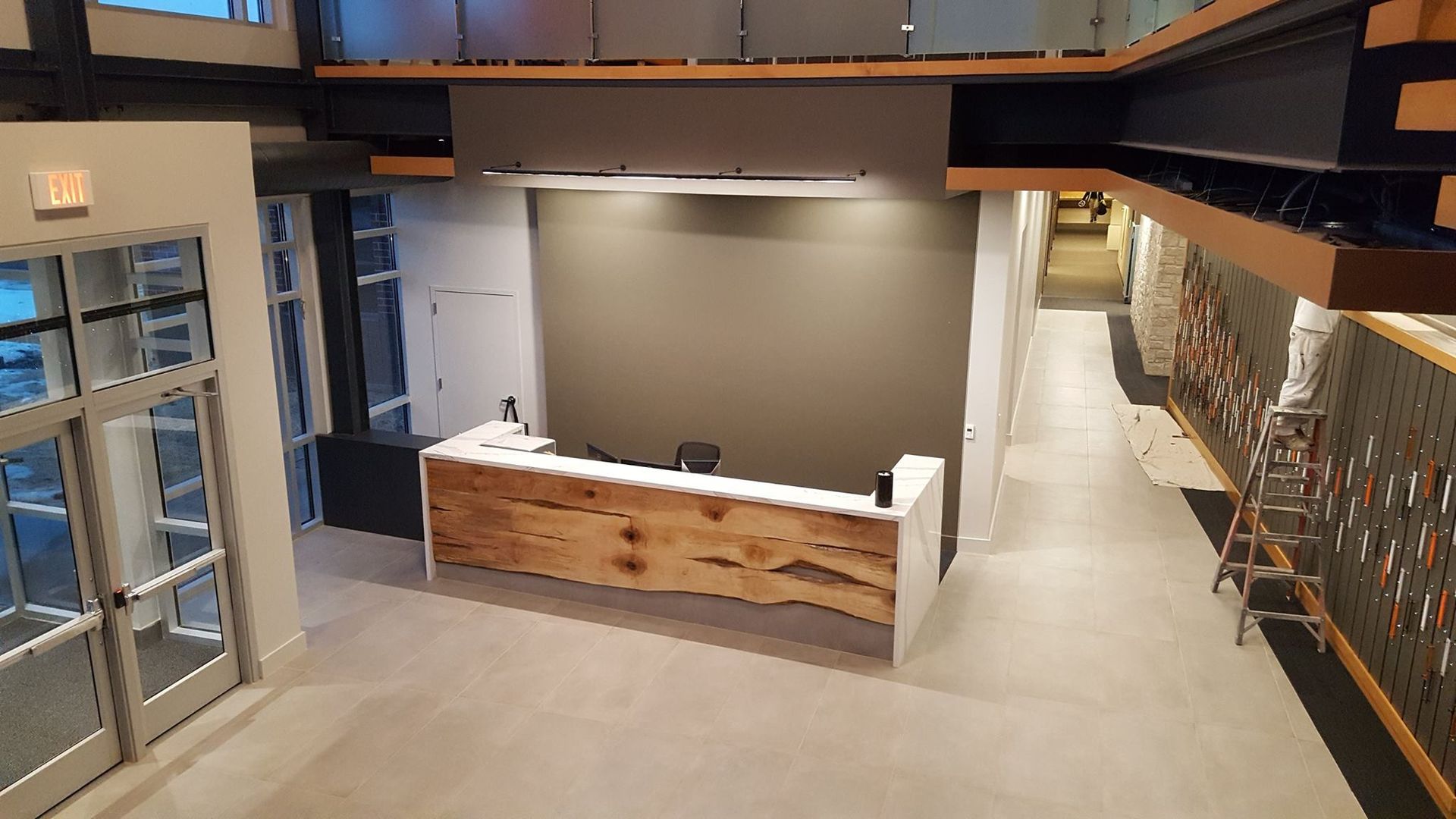 An aerial view of a lobby with a wooden reception desk