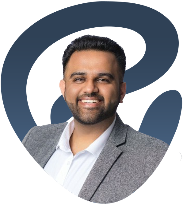 Smiling man in a gray blazer on a white background with a large blue abstract logo