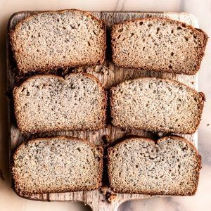 Six slices of seeded bread arranged in a 2-by-3 grid on a tray.