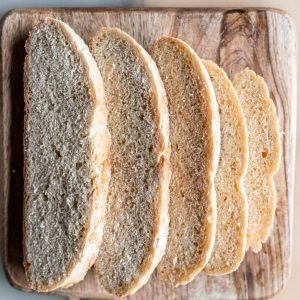 Sliced rustic bread on a wooden cutting board