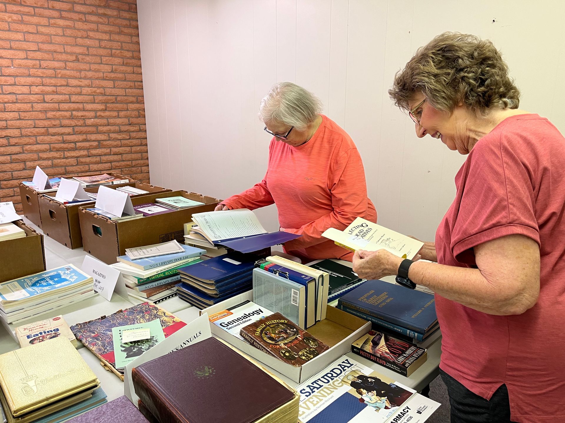  GCHGS members looking through stacks of books