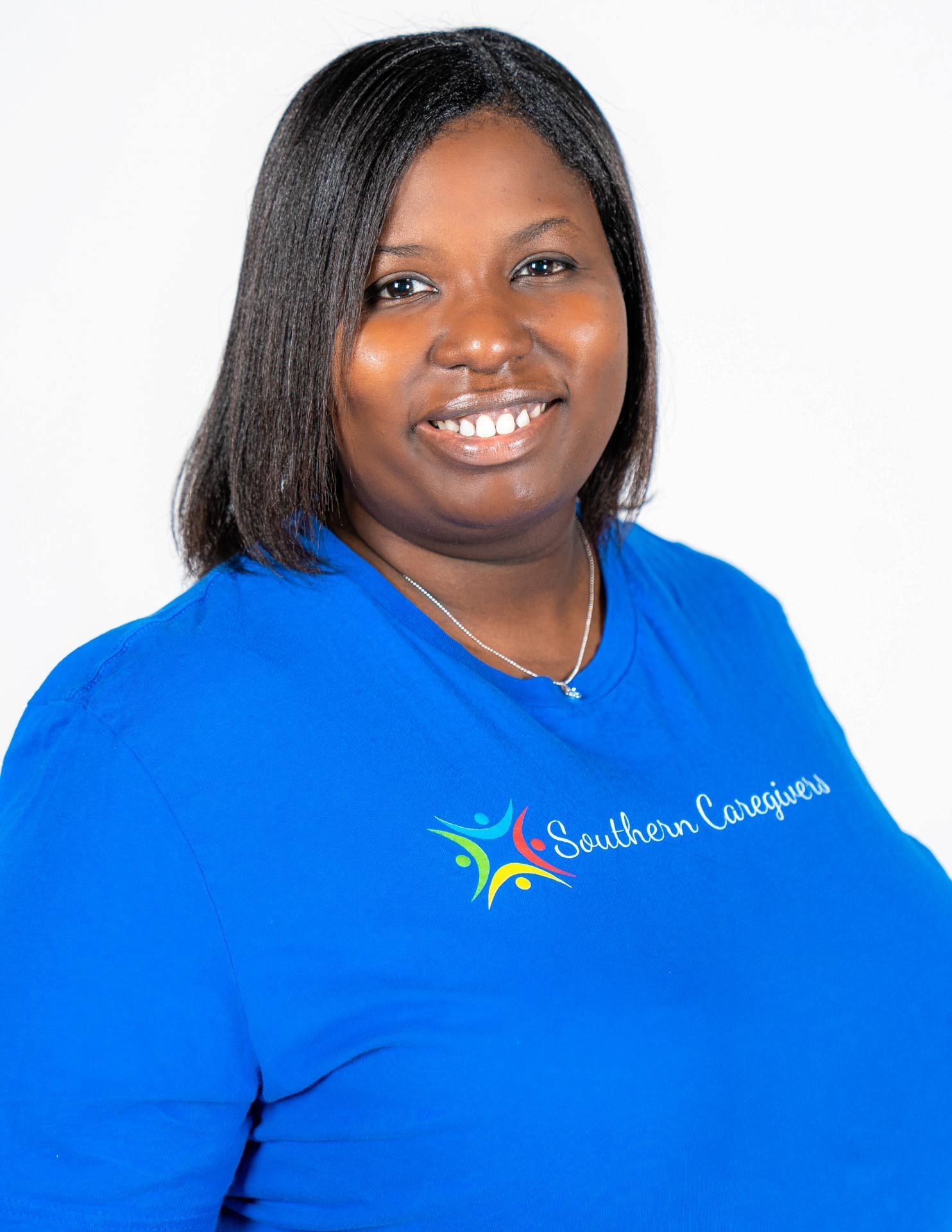 Smiling person in a bright blue shirt against a white background