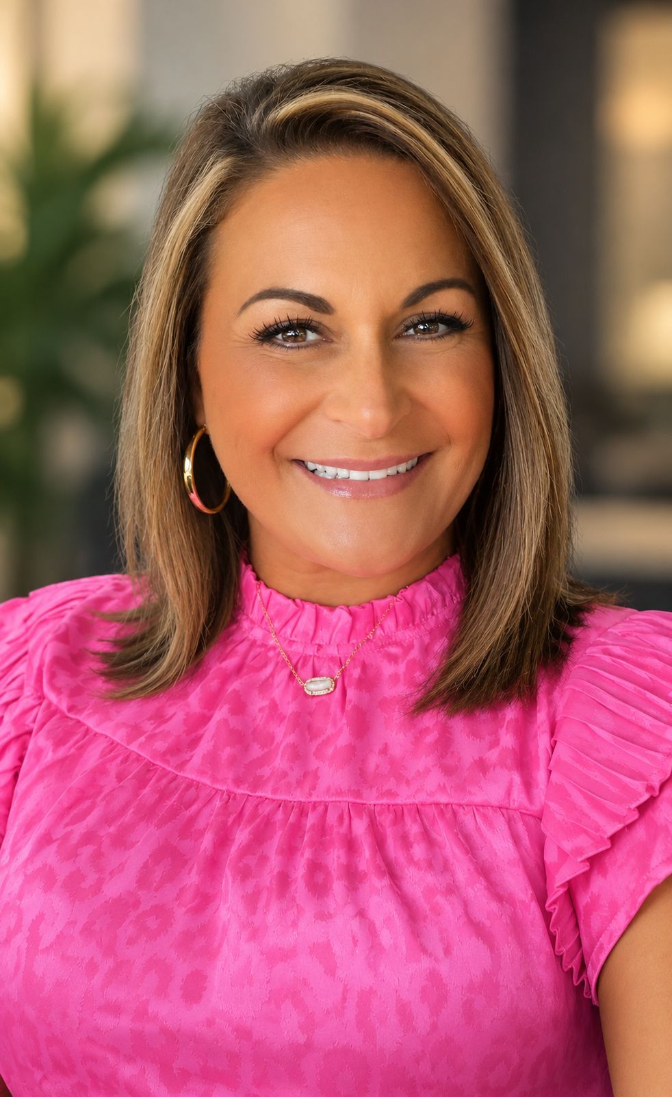 Smiling person in a black Southern Caregivers T-shirt standing against a plain light wall