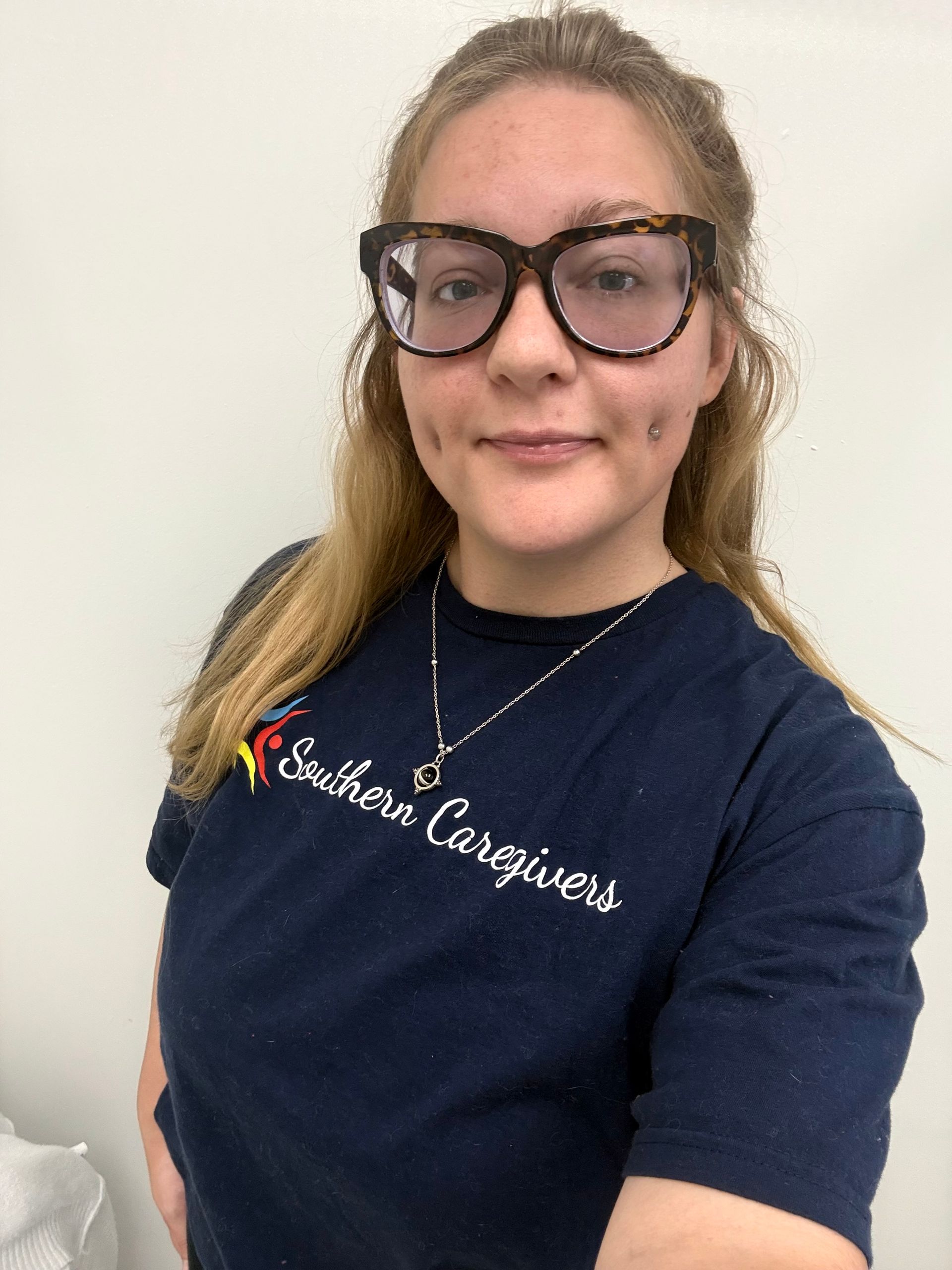 a professional headshot of T Holley wearing a southern caregivers t shirt