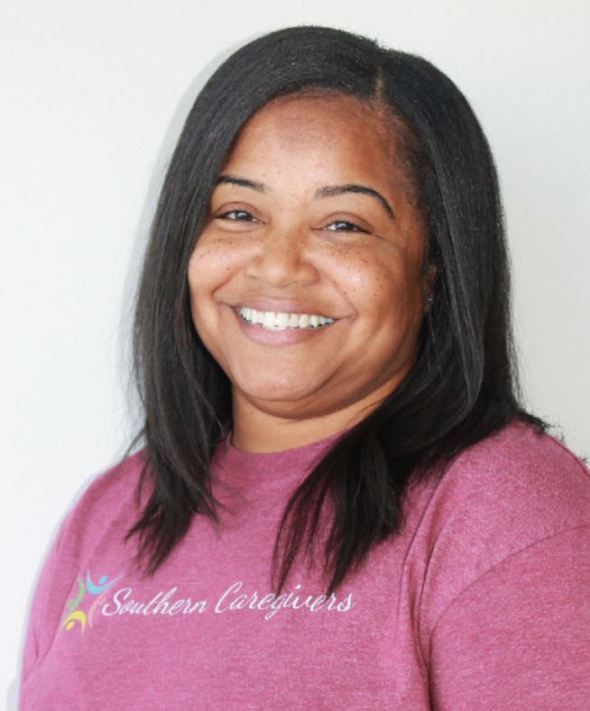 Smiling woman in a pink shirt against a light background