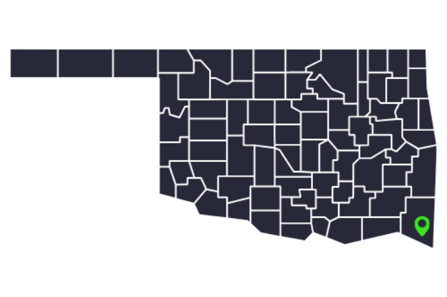 Oklahoma county map in dark gray with white borders and a green location pin in the southeast