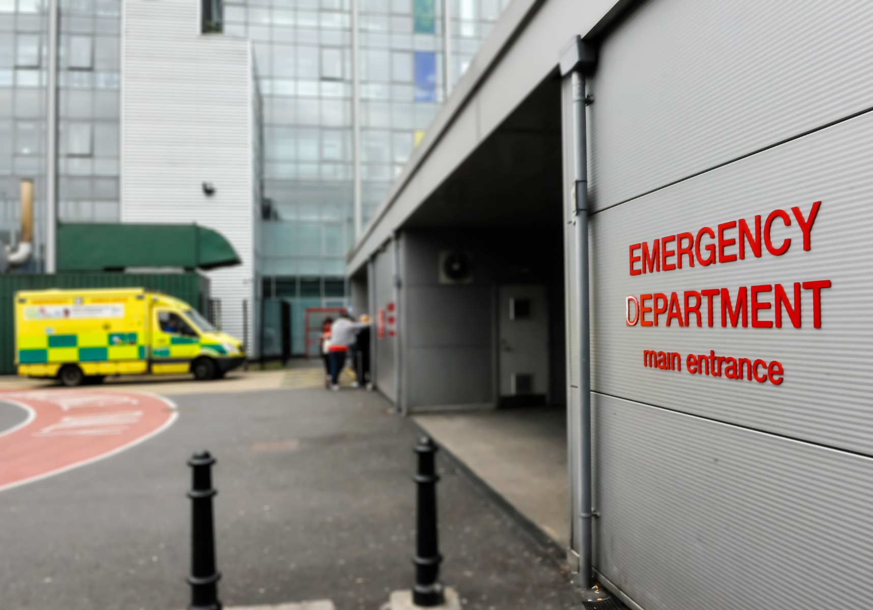Hospital emergency department main entrance with ambulance parked outside