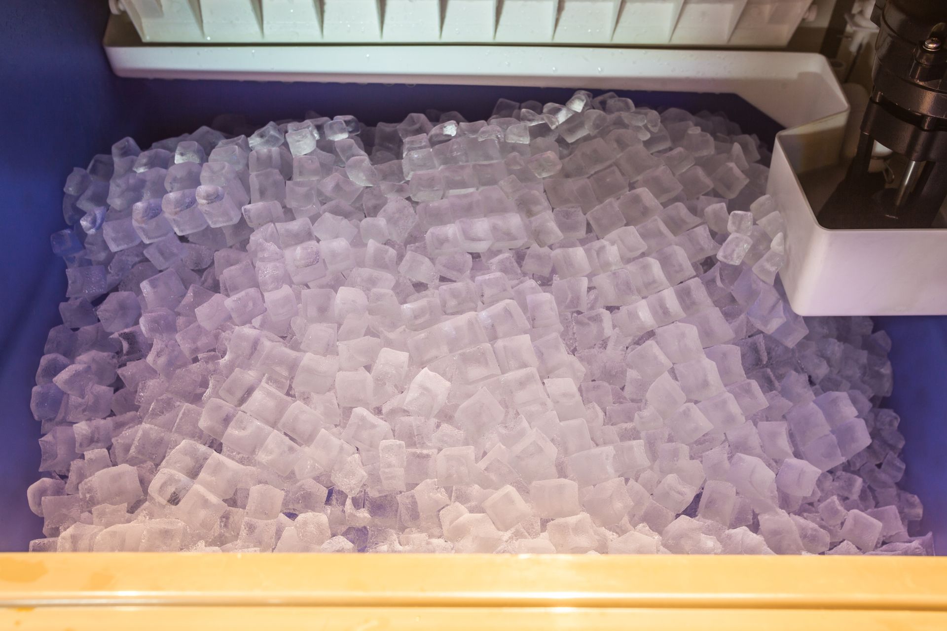 Close-up of ice inside commercial unit, full bin highlights quality ice machine repair results.