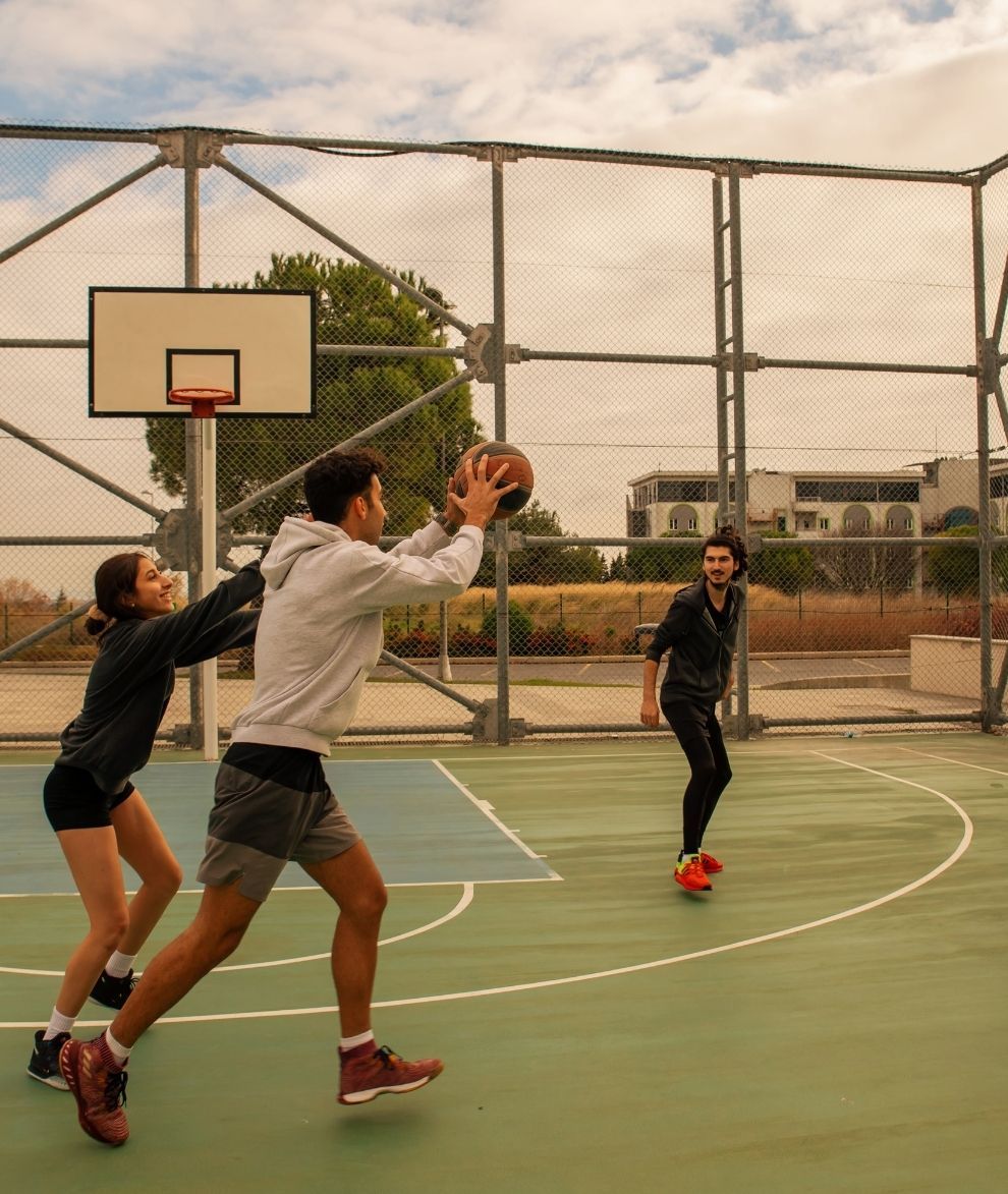 Young athletes playing a game of pickup basketball.