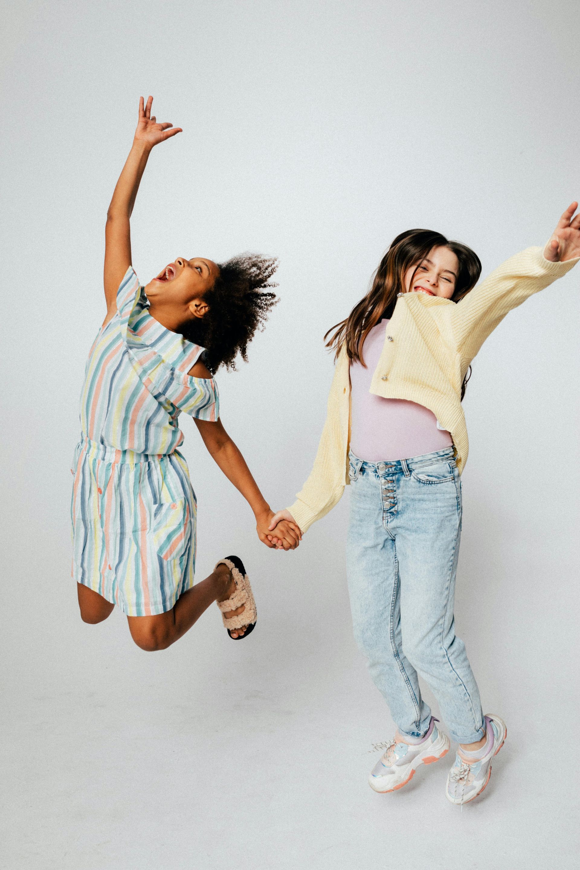 Two girls jumping in the air.