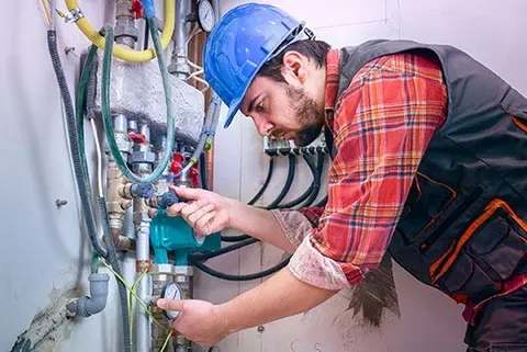 Technician Repairing Heating System — Indianapolis, IN — Roy Rogers HVAC