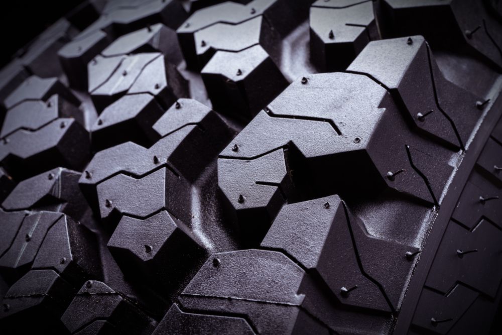 Close-Up Of Dark Tire Tread With Angular Blocks And Studs — Ballina Car Centre in Ballina, NSW