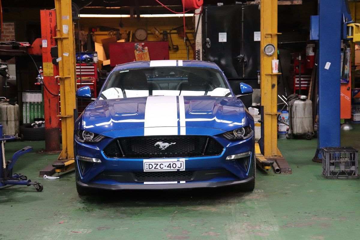 Blue Ford Mustang With White Stripes In Garage — Ballina Car Centre in Ballina, NSW