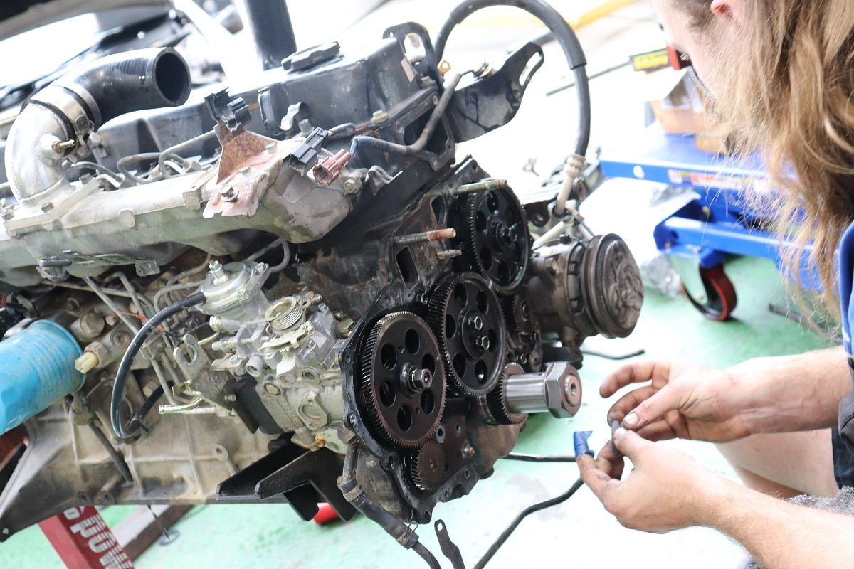 Mechanic Working On Car Engine Removing Parts With Tools — Ballina Car Centre in Ballina, NSW