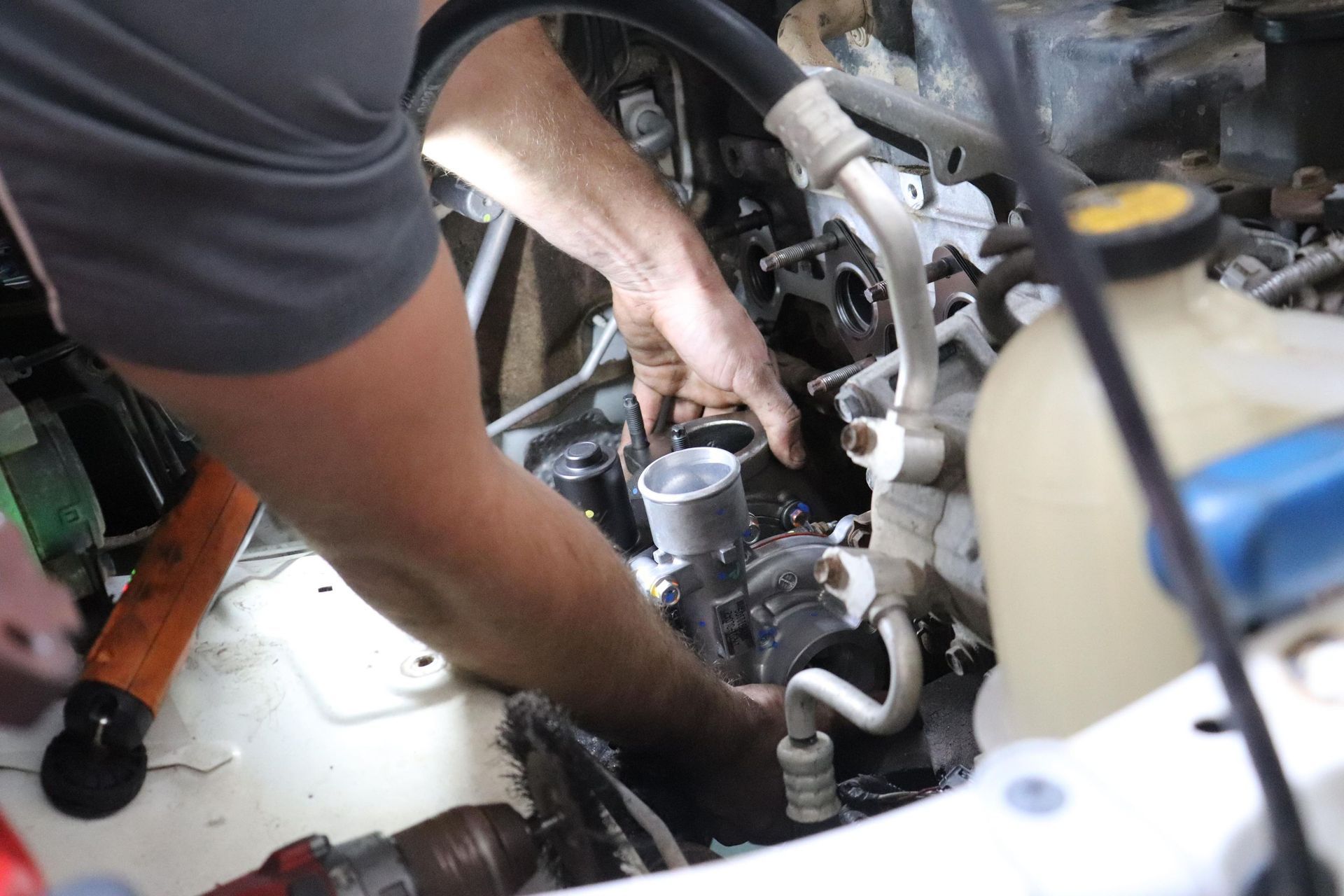 Mechanic Working On Car Engine With Tools And Parts Visible — Ballina Car Centre in Ballina, NSW