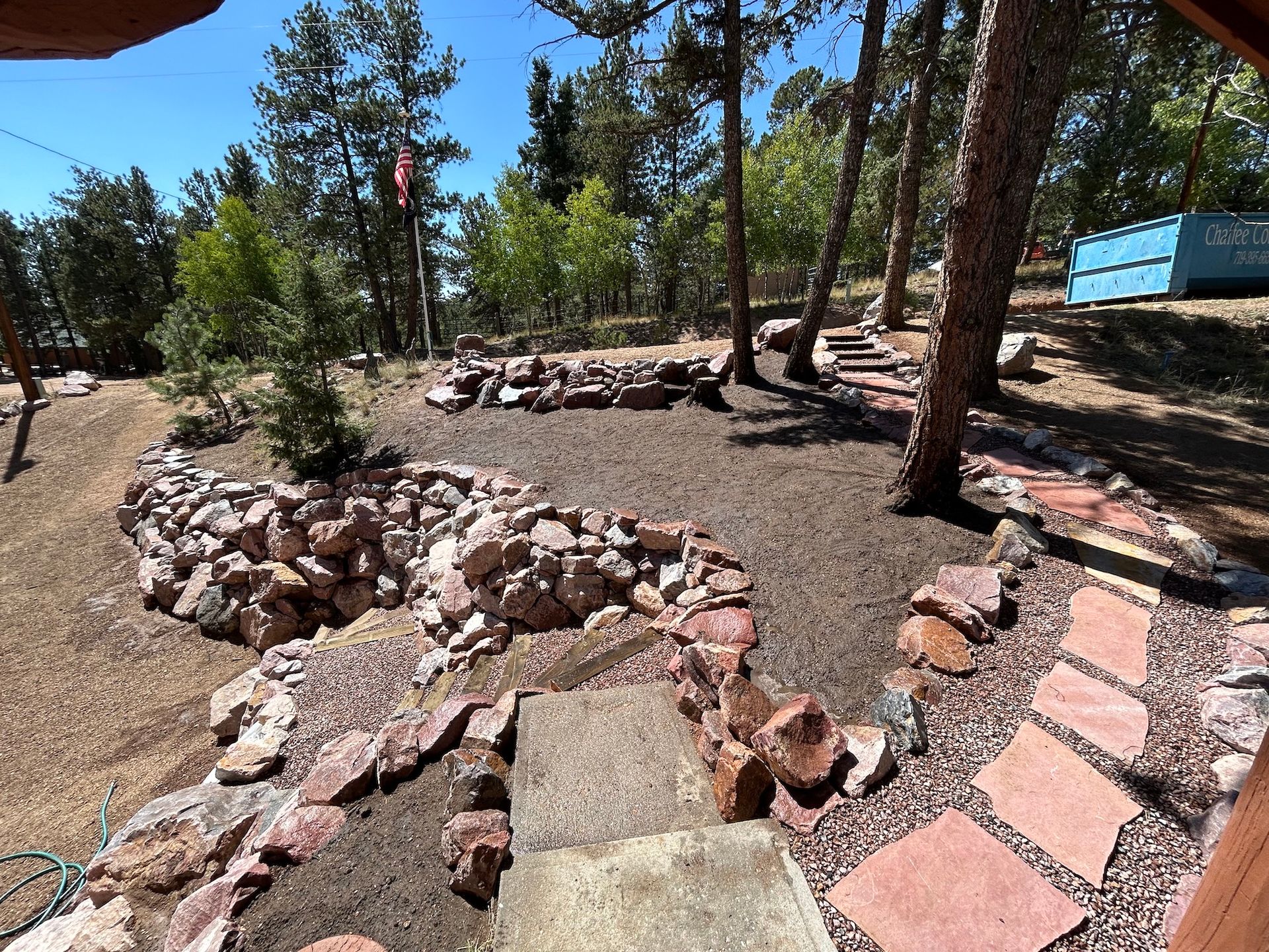 A lush green forest with a lot of rocks and trees