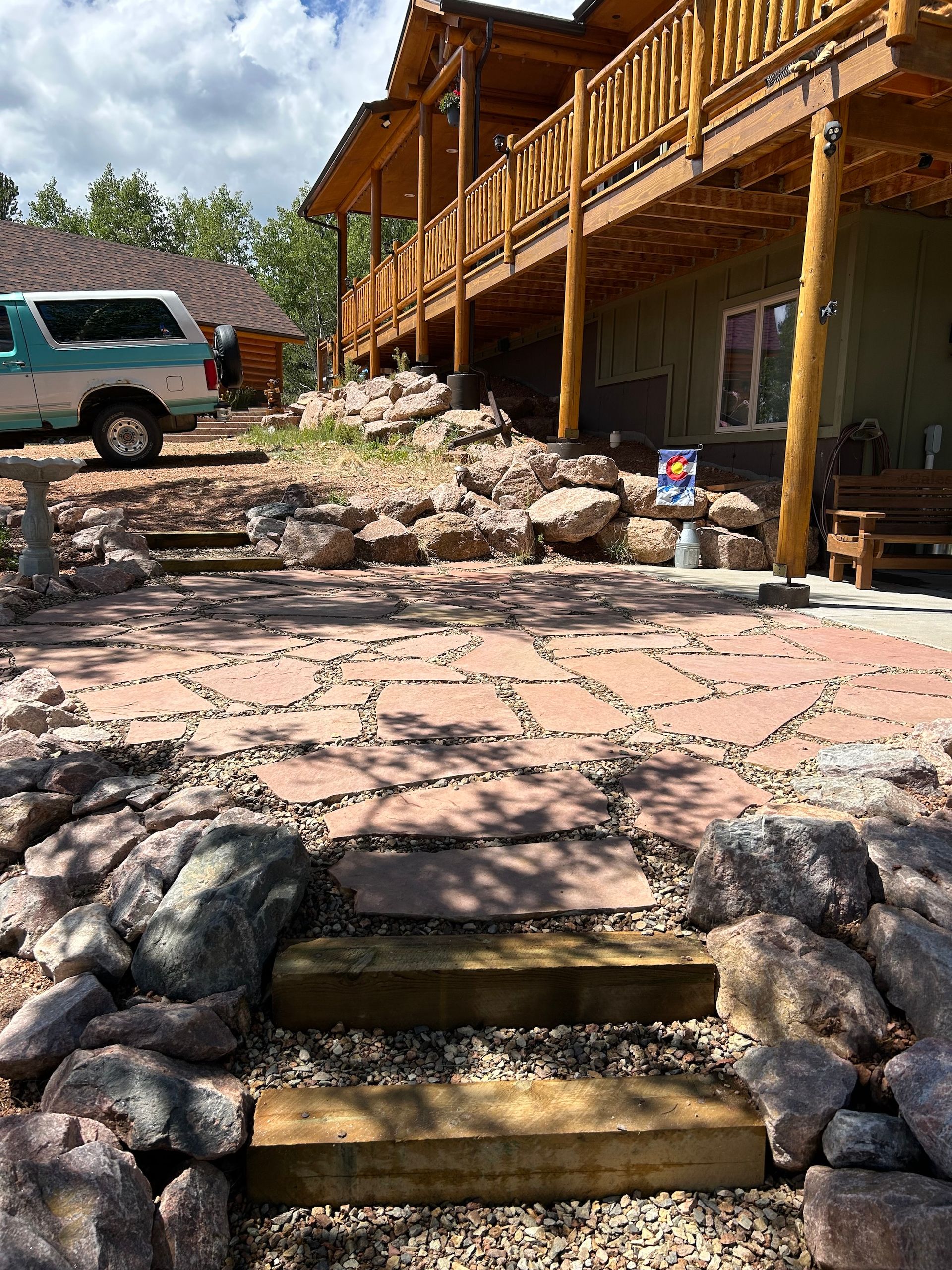 A staircase leading up to a house with a car parked in front of it.