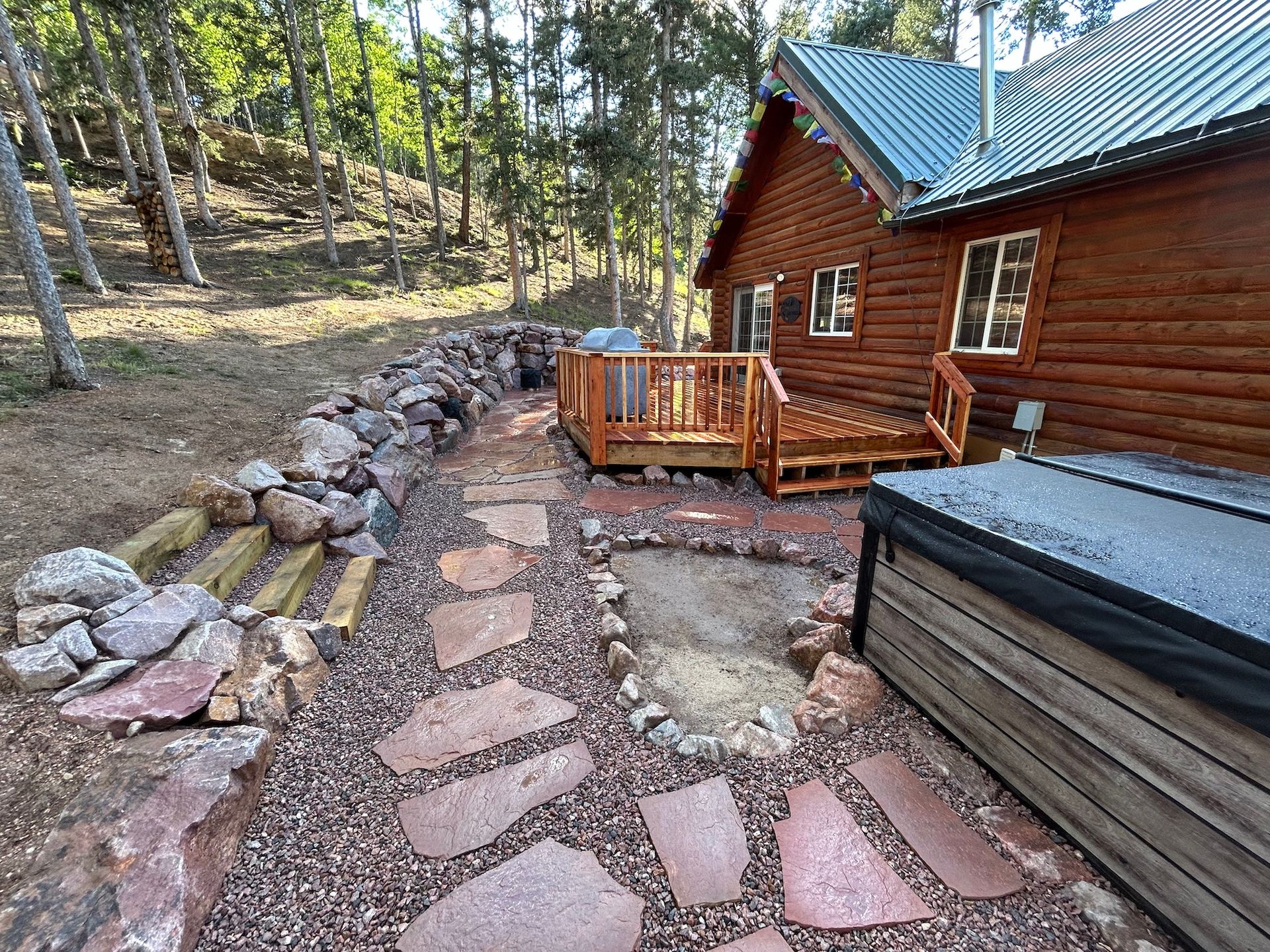 A log cabin with a hot tub in front of it.
