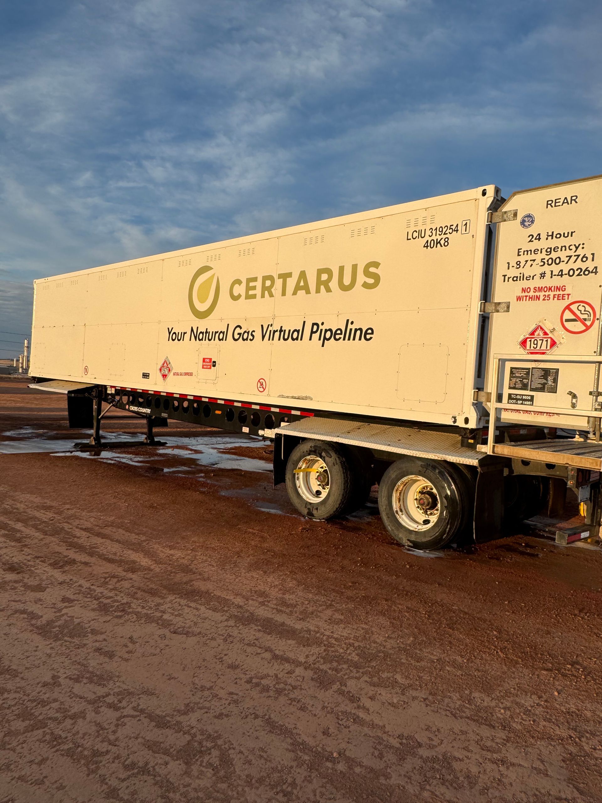 White CERTAUS semitrailer on muddy road under blue sky at sunset