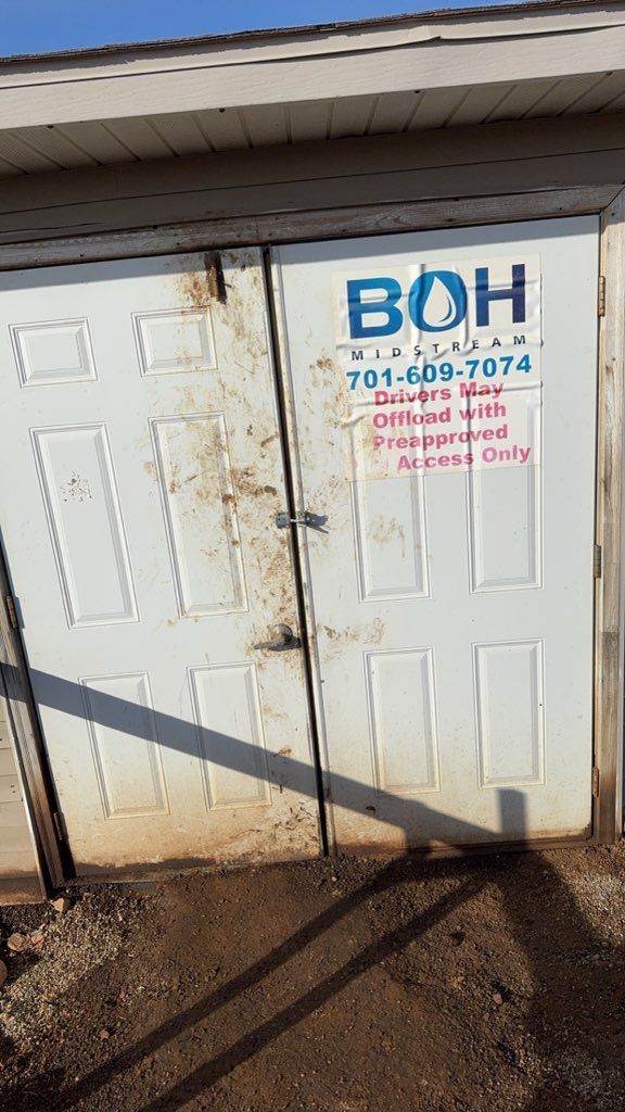 White utility doors with a BOH sign and phone number on a small building exterior
