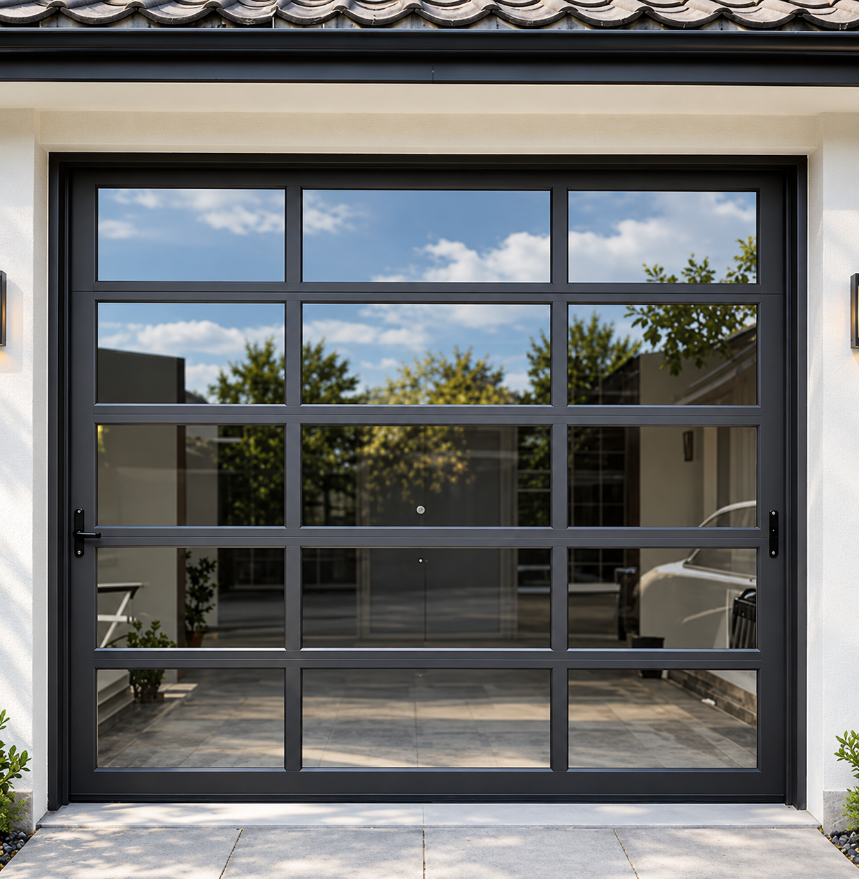 Black-framed glass sliding door reflecting a patio and trees, with a tiled roof above