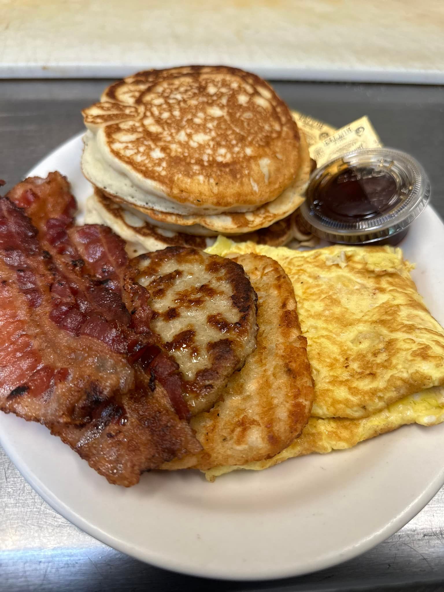 Restaurant Menu - Burger and bacon flatbread sandwich with a side salad and dressing.