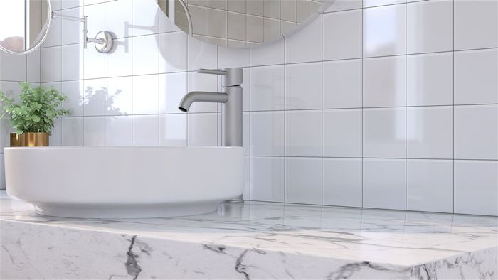 A bathroom with a sink, mirror and marble counter top.