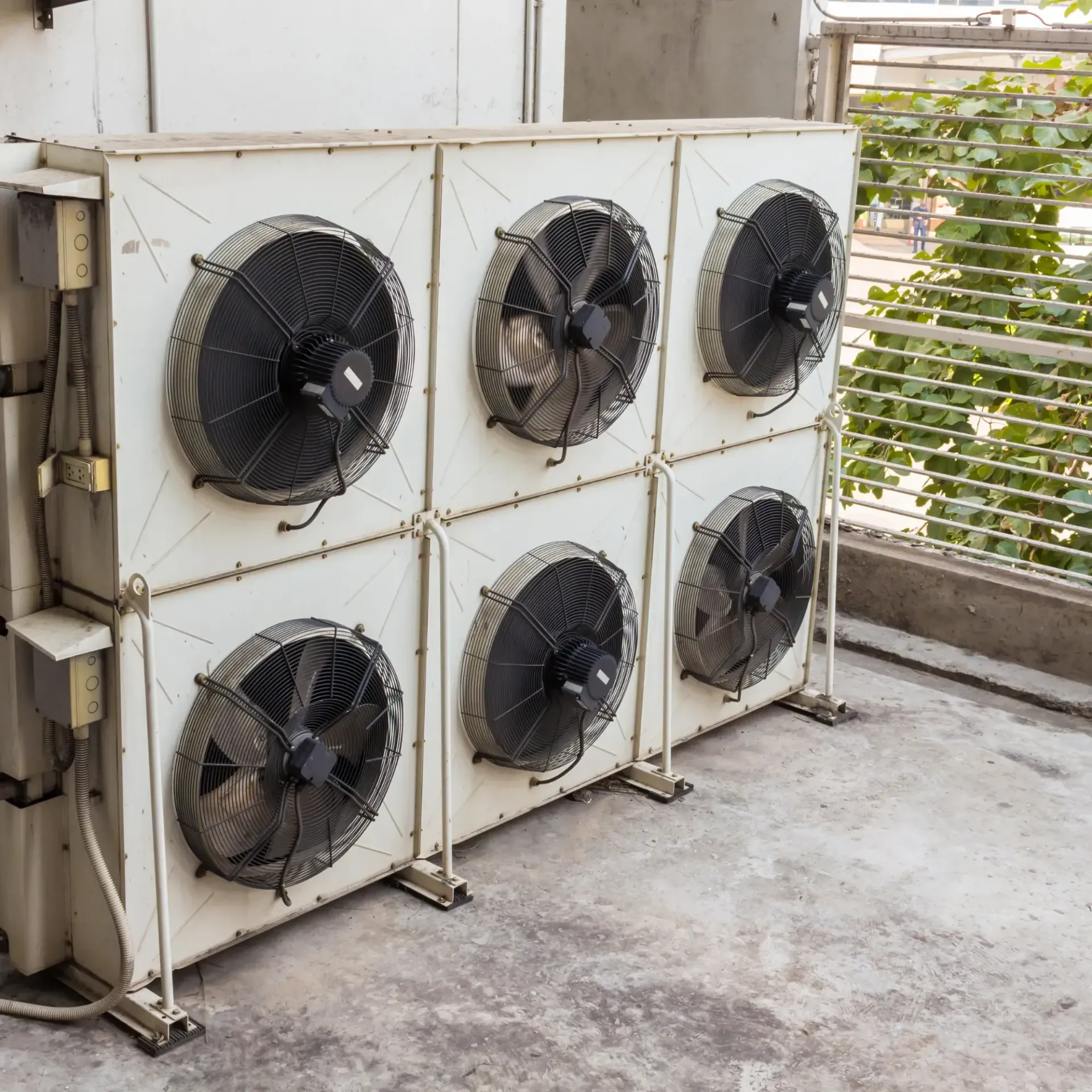 Aarden Air Service Heating & Air Conditioning- A row of air conditioners are lined up on the side of a building.