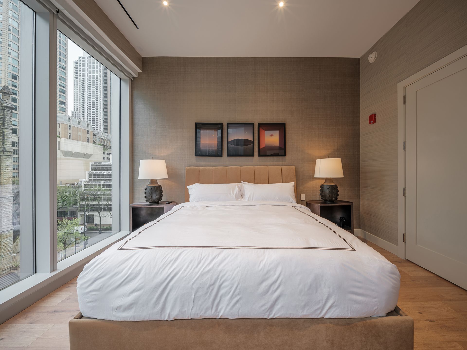 A bedroom with a large bed and a large window